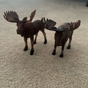Two moose figurines